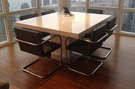 Modern styled office featuring custom upholstered conference chairs with metal frame overlooking the Manhattan skyline by Bespoke by Luigi Gentile.