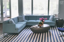 Stunning custom Greenwich sectional with durable wooden legs and modular shape designed by Bespoke by Luigi Gentile as seen in this space designed by MB Shapes & Forms.