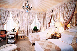 Traditional styled shared bedroom with two custom twin bell shaped headboards and pleated draperies. Upholstery and Draperies by Bespoke By Luigi Gentile. Interior Design by Scott Salvator.