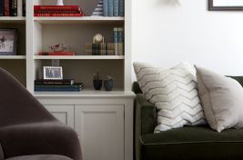 Closeup of a green mohair custom upholstered Greenwich sofa with wood rail base. Room designed by Ali Reeve, custom sofa by Luigi Gentile.