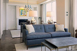 Custom Greenwich sofa with button tufted back seat and wood rail overlooking a contemporary styled Manhattan apartment. Interiors: Renee Infantino. Upholstery: Bespoke by Luigi Gentile
