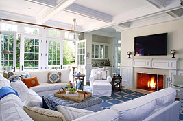 A traditional styled custom upholstered wrap around armless sectional designed to contour the space with additional Bridgewater swivel chairs for additional seating. Interiors: Penny Drue Baird. Upholstery: Bespoke by Luigi Gentile