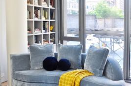 Front view of a custom curved blue velvet sofa by Bespoke by LG. Interiors: Cary Jones Design. 