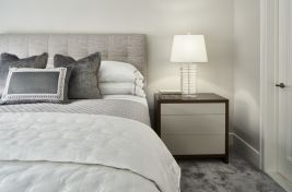 Close up on a stunninng white and grey bedroom on the Upper East Side. Featuring our custom nightstands and our custom square tufted headboard. Upholstery: Bespoke by Luigi Gentile. Interiors: Gale Sitomer. Photography: Alex Kroke