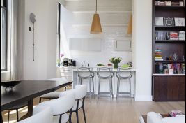 Elegant custom live edge walnut dining table in this sun drenchedNew York City apartment. rnTable: Bespoke by Luigi GentilernDesigner: Rona Landman