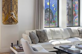 Modern and inviting custom left arm facing upholstered sectional with a drink tray paired with a custom blackened steel metal coffee table and live edge walnut dining table created by Bespoke by Luigi Gentile in this luxurious New York City apartment. \r\nInteriors: Rona Landman\