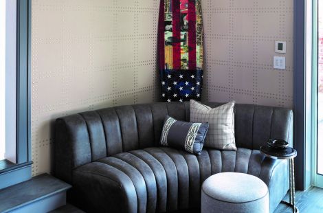 Custom curved channeled upholstered armless sofa in chic grey leather. \r\nDesigner: Robyn Karp Designs\r\nUpholstery: Bespoke by Luigi Gentile