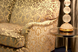 Close up on a custom upholstered traditional styled Sullivan Bridgewater Sofa with tapered wooden legs with castors. Upholstery by Bespoke by Luigi Gentile. 