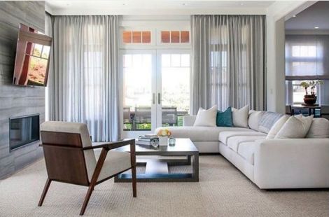 Exquisite right-arm facing modular custom upholstered white sofa with a left arm facing bespoke chaise, plinth base with loose back pillows in this fabulous Hamptons home, designed by Betty Wasserman. Upholstery: Bespoke by LG in NYC. 
